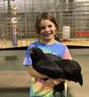 Sydney with Big Bird. Champion Jr Large Fowl, black Ameraucana Pullet